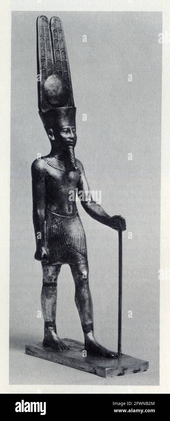 Statuetta d'argento con dettagli in oro di Amun con la sua caratteristica testa-abito di una corona sormontata da un disco e alti pennacchi Foto Stock
