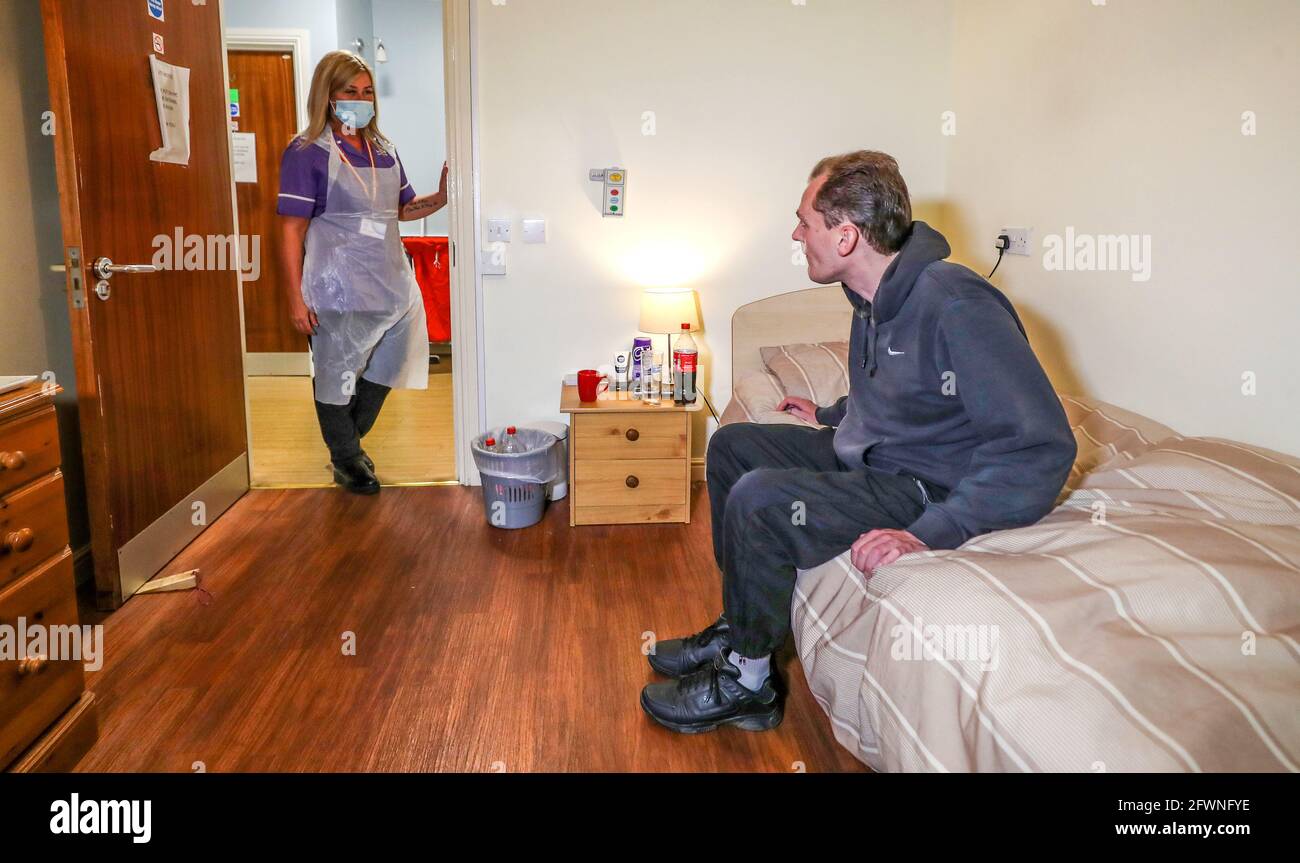 File foto datata 20/07/2020 di cura operatrice Cath Roe che parla con Darren Mitcheson residente nei suoi giri a Ashwood Court casa di cura residenziale a Lowton, Warrington. Costringere gli operatori sanitari ad avere un vaccino contro il coronavirus rischia di controfirarsi perché potrebbero ancora chiudere una bramura se sono stati minacciati o non hanno dato consulenza dal loro datore di lavoro, un’Unione leader è un avvertimento. Data di emissione: Lunedì 24 maggio 2021. Foto Stock