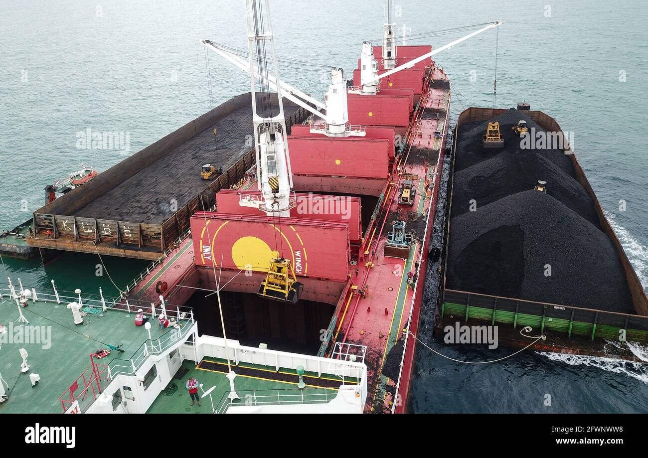 Trasporto del carbone dalla chiatta alla vista aerea della nave madre Foto Stock