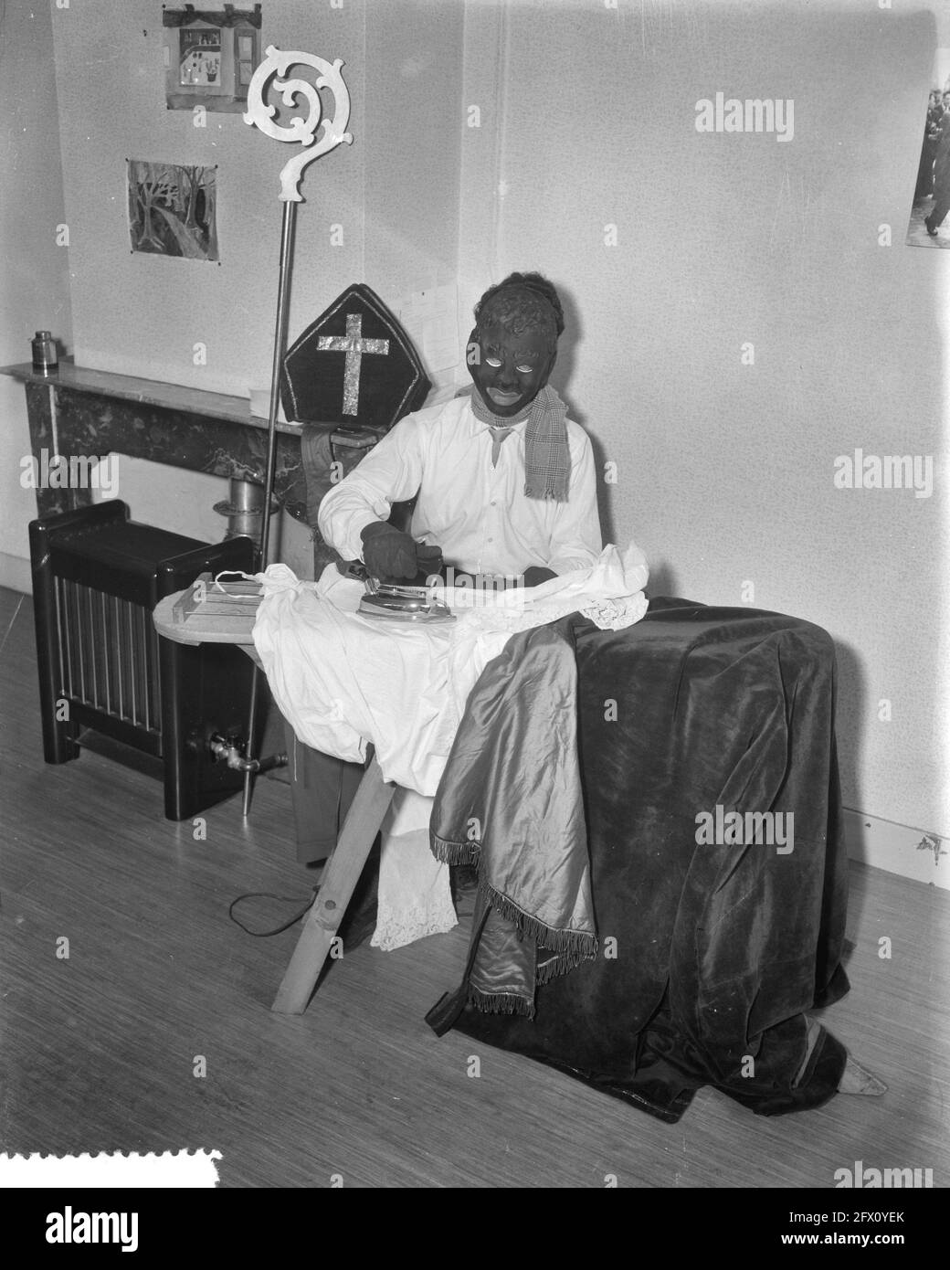 Zwarte Piet stirare la tavola di Sinterklaas, 9 novembre 1956, miters, pieten, ferro da stiro, Paesi Bassi, foto agenzia stampa del XX secolo, notizie da ricordare, documentario, fotografia storica 1945-1990, storie visive, Storia umana del XX secolo, che cattura momenti nel tempo Foto Stock