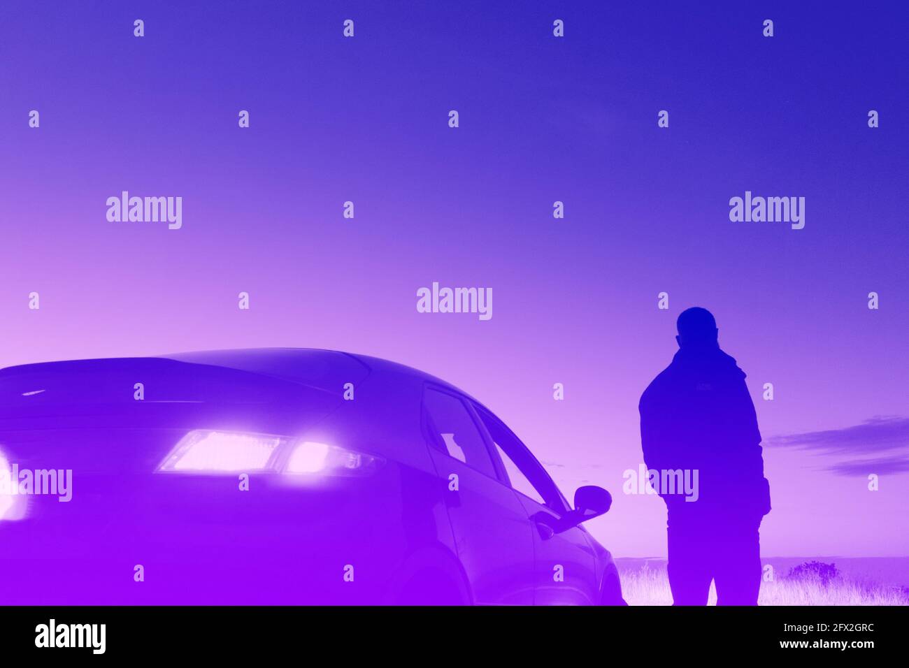 Un uomo che guarda il tramonto accanto a una macchina con i fari accesi. In  una serata estiva. Con una modifica digitale al neon e a vaporonda Foto  stock - Alamy