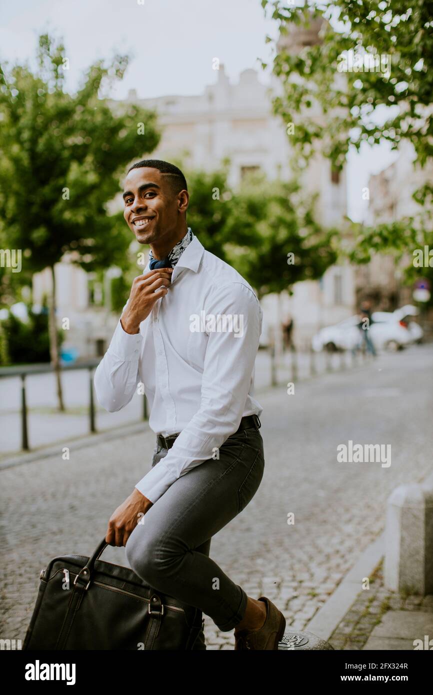 Bell'uomo d'affari afro-americano che ha in attesa di un taxi su un via Foto Stock