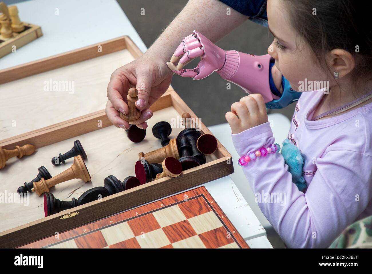 Mosca, Russia. 25 Maggio, 2021. I bambini con le mani protesiche giocano a scacchi al Geek Day Festival al Winzavod Contemporary Art Center il Geek Pride Day Foto Stock