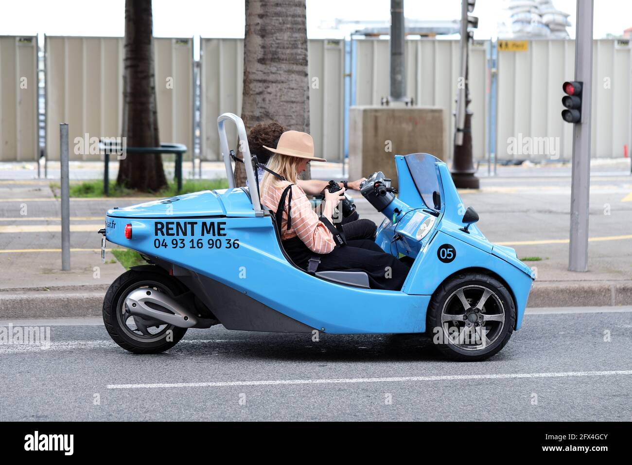 Nizza, Francia - 21 maggio 2019: Giovane coppia di turisti in piccolo Blue  Noleggio Auto da NiceCar, Funny tre ruote veicolo in via di Nizza, francese  R Foto stock - Alamy