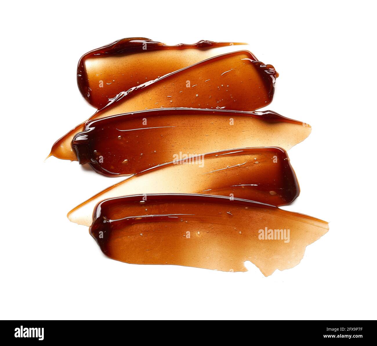 Striscio di gel color cioccolato e consistenza. Gel cosmetico o sciroppo di caramello su fondo bianco Foto Stock