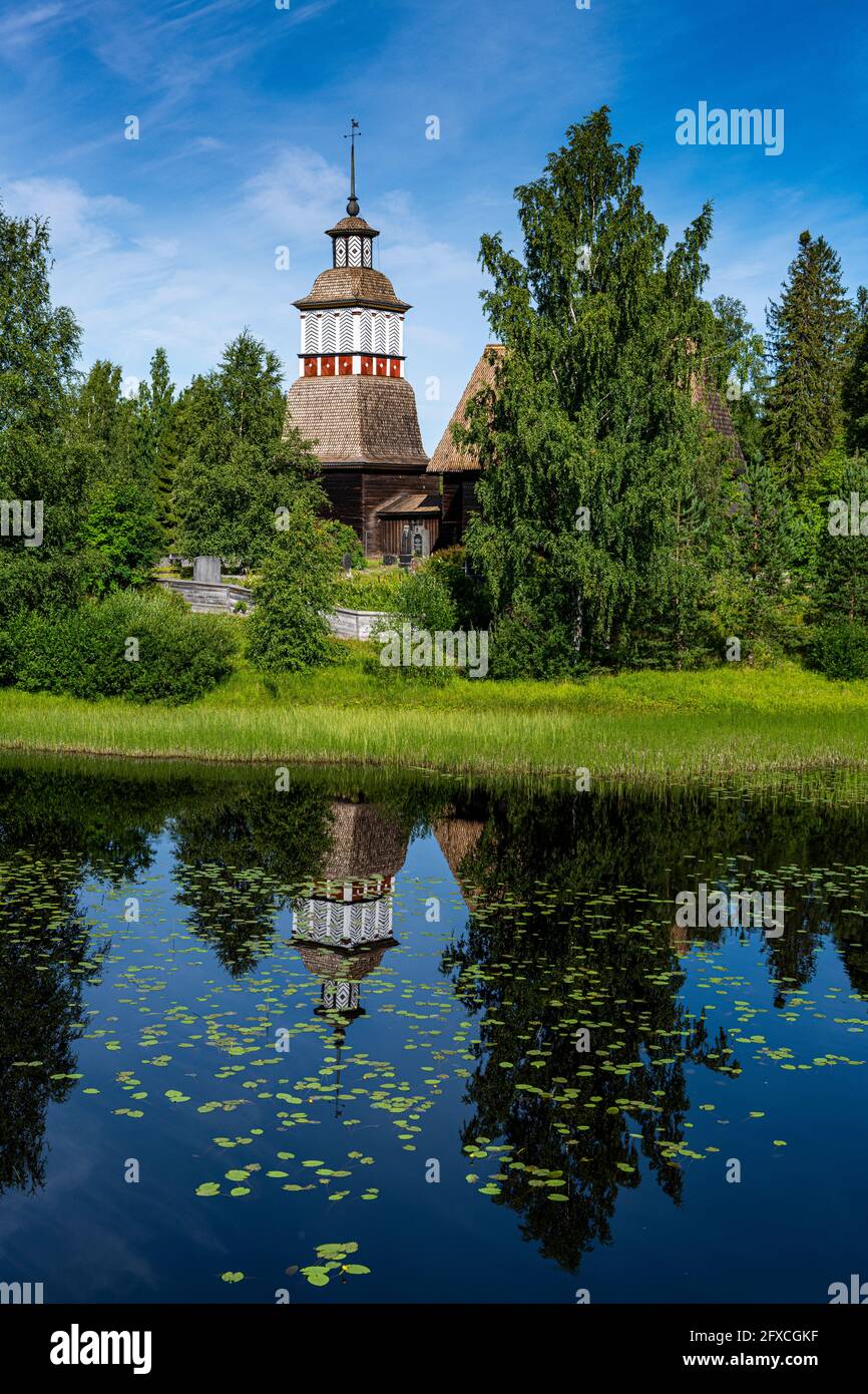 Chiesa di legno che si riflette in lago lucido Foto Stock