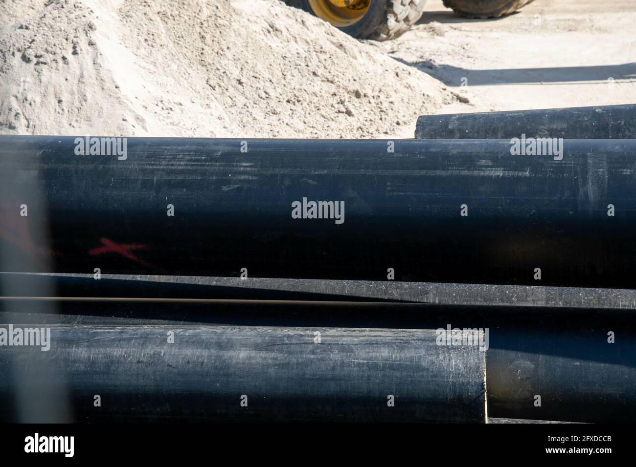 Un lotto di tubi di plastica neri nell'area di costruzione Foto Stock