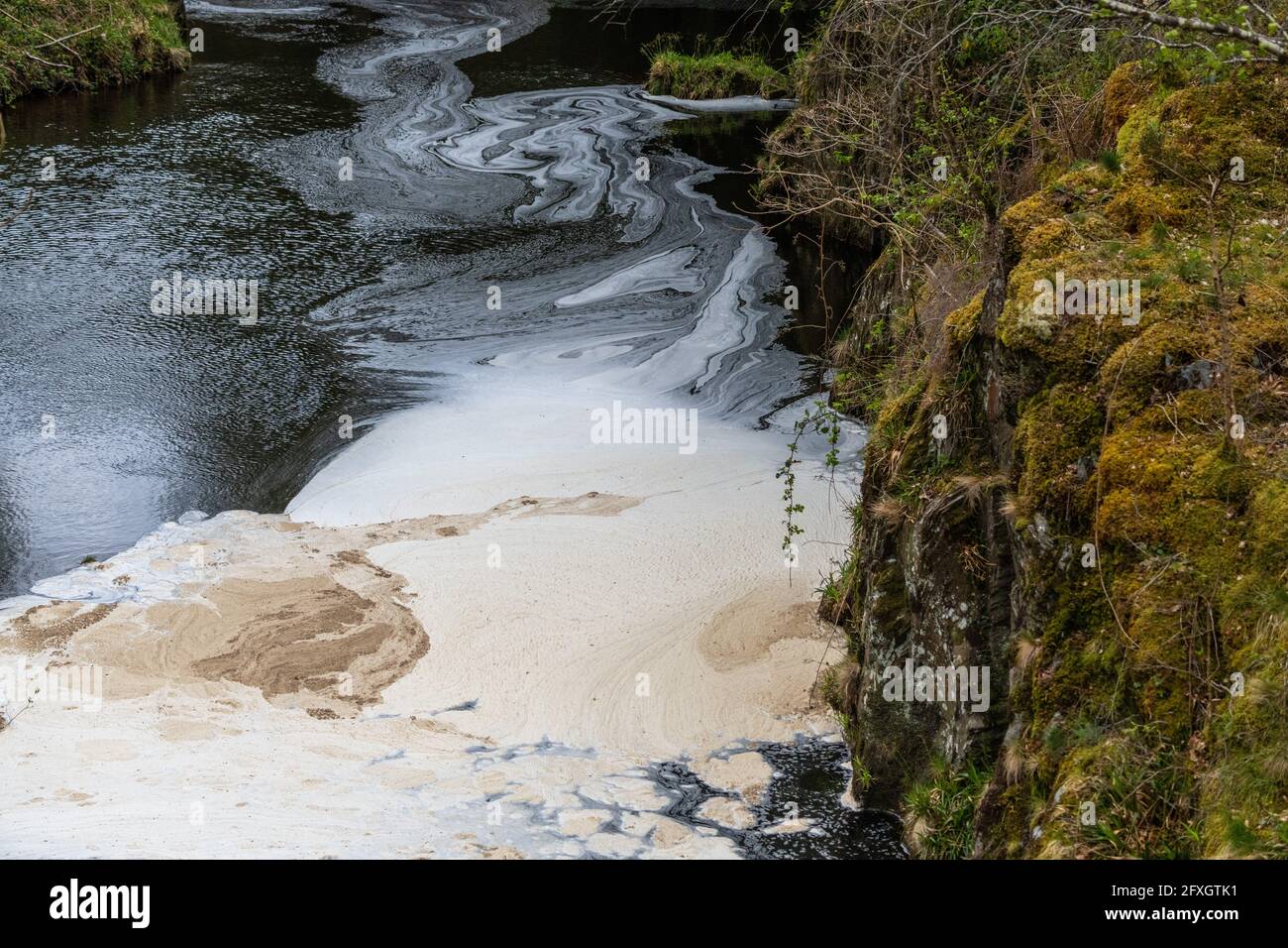 Inquinamento idrico in un fiume che scorre da una vecchia miniera di piombo disutilizzata in Galles dopo essere passato attraverso un impianto di trattamento delle acque Foto Stock