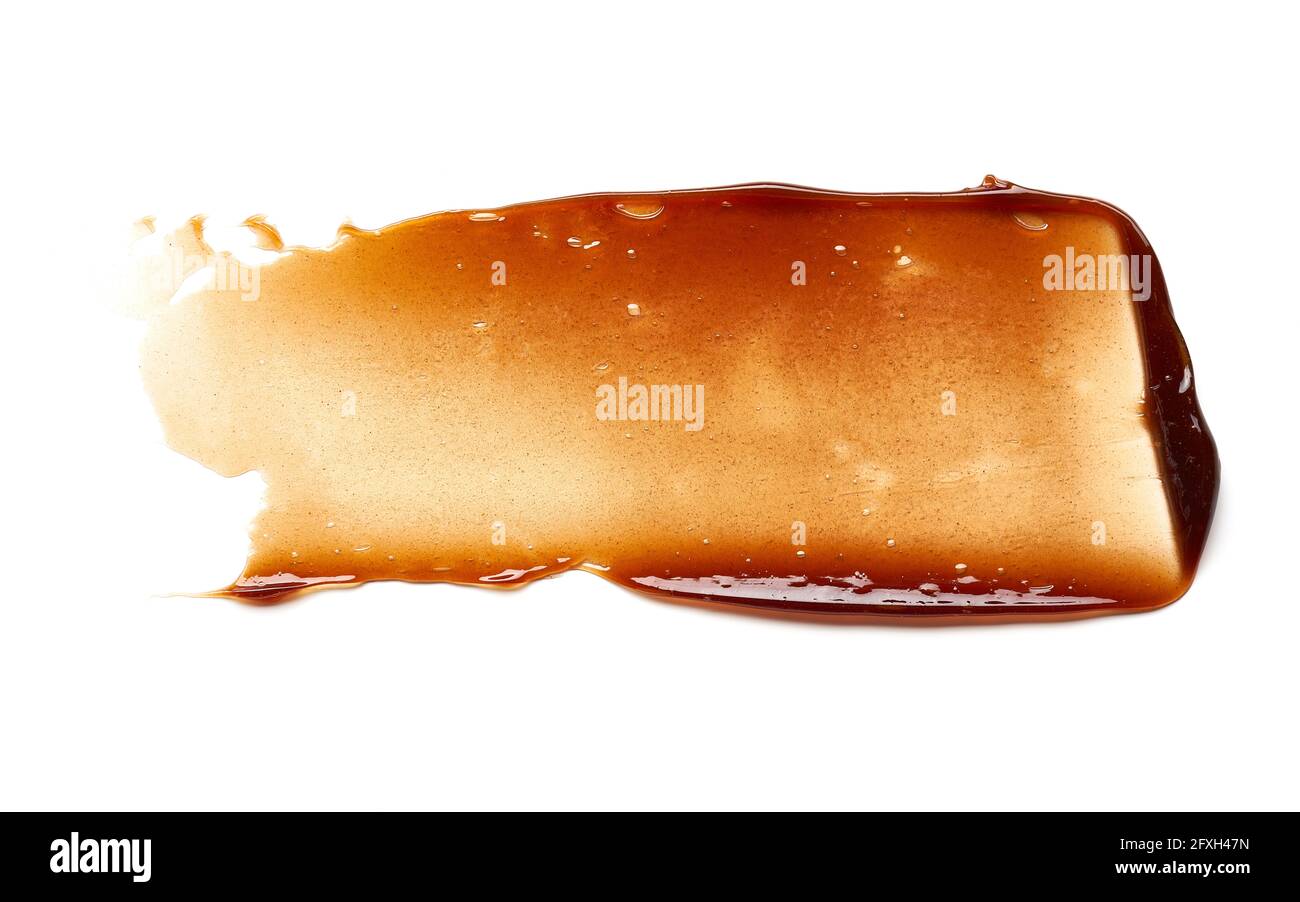 Striscio di gel color cioccolato e consistenza. Gel cosmetico o sciroppo di caramello su fondo bianco Foto Stock