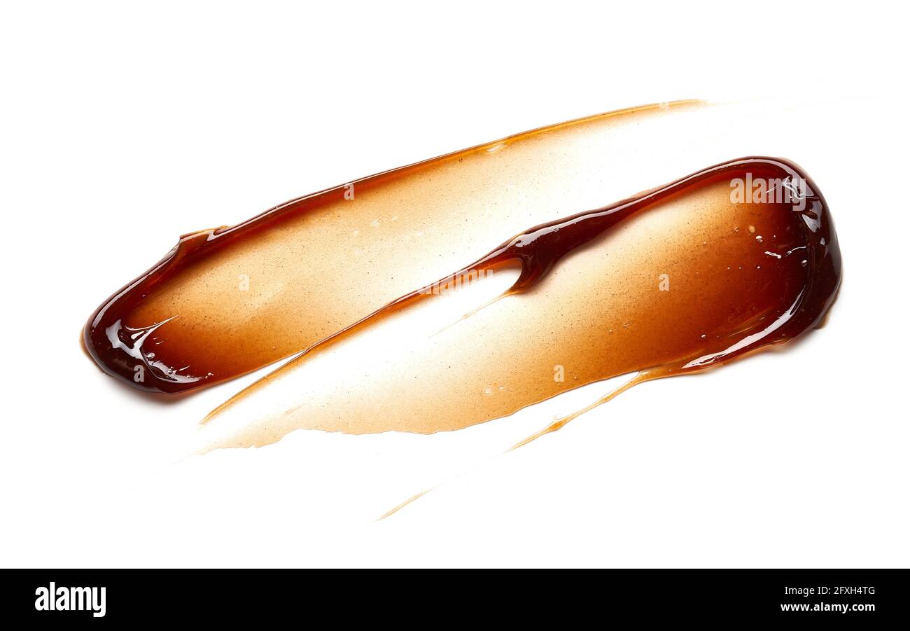 Striscio di gel color cioccolato e consistenza. Gel cosmetico o sciroppo di caramello su fondo bianco Foto Stock