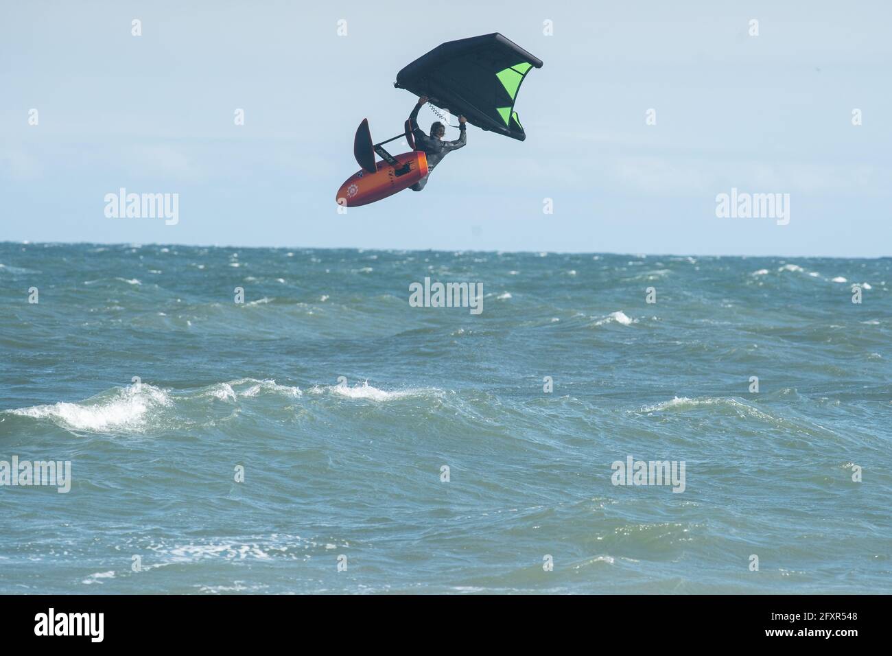 Il surfista professionista James Jenkins vola sopra l'Oceano Atlantico sul suo surfista di ala a Nags Head, Carolina del Nord, Stati Uniti d'America, America del Nord Foto Stock