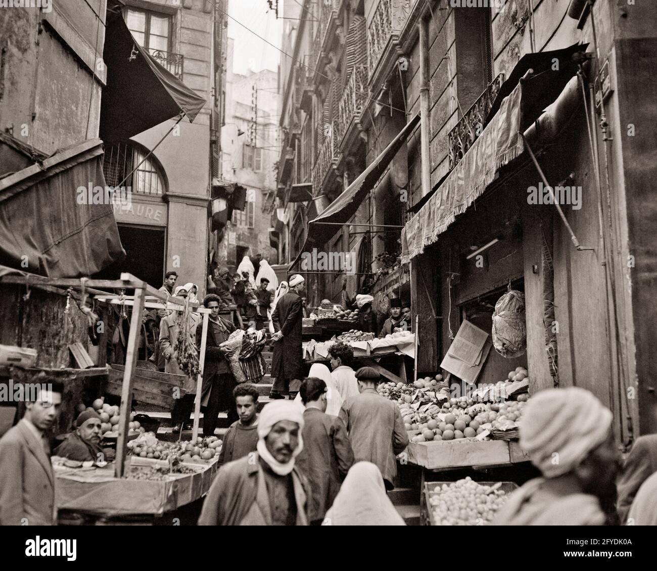 1950 1960 STRETTO MERCATO ARABO VIA ALGERI ALGERIA - r15559 RGE001 HARS ADVENTURE STREETS LOW ANGLE 1962 STRETTE CAPITALI ALGERIA ARABI MEDITERRANEO ARABO MERCATO ARABO BIANCO E NERO NORD AFRICA VECCHIO STILE Foto Stock