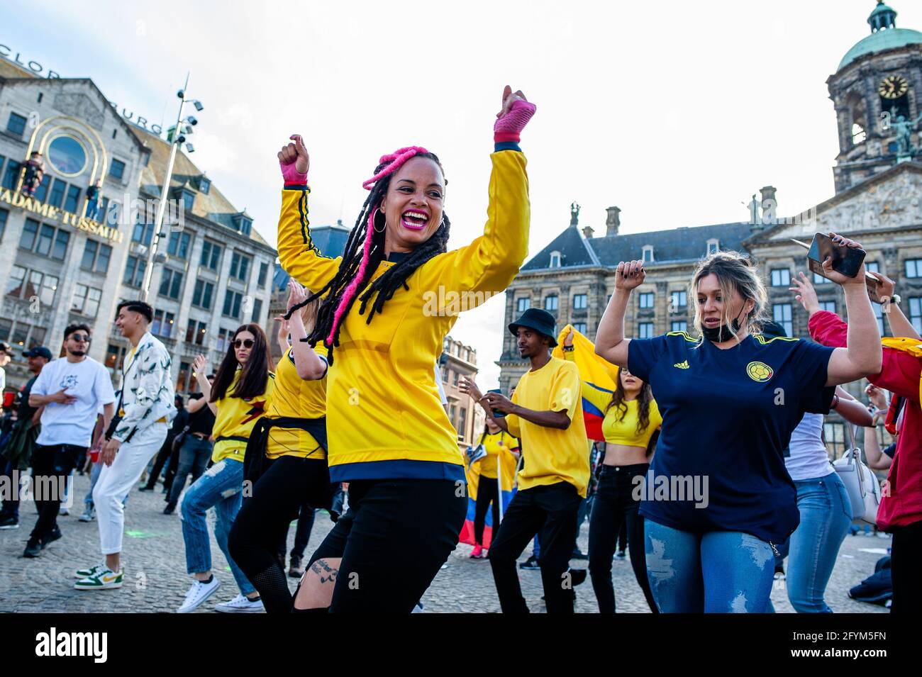 Amsterdam, Paesi Bassi. 28 maggio 2021. Un gruppo di colombiani che danzavano con la musica colombiana durante la manifestazione.migliaia di manifestanti hanno marciato nelle città della Colombia per celebrare un mese di manifestazioni diffuse. Nei Paesi Bassi, la comunità colombiana ha organizzato una protesta nel centro della città contro il governo del presidente Iván Duque e la violenza della polizia. La manifestazione ha camminato verso l'ambasciata colombiana e fatto ritorno a Piazza Dam, dove i manifestanti hanno danzato a sostegno del loro paese. Credit: SOPA Images Limited/Alamy Live News Foto Stock