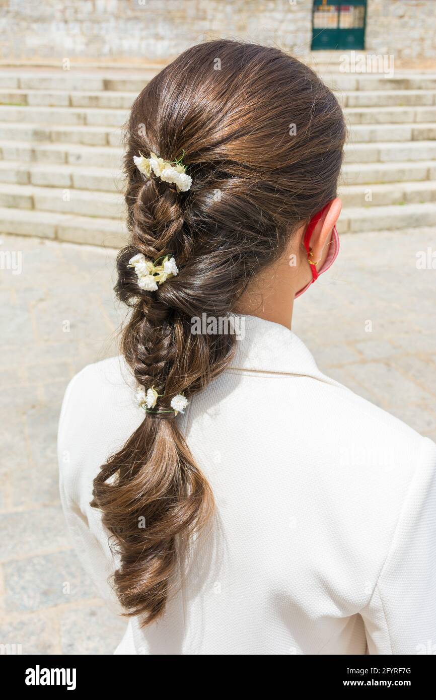 Giovane ragazza con treccia o treccia, capelli lunghi in una cerimonia di nozze Foto Stock