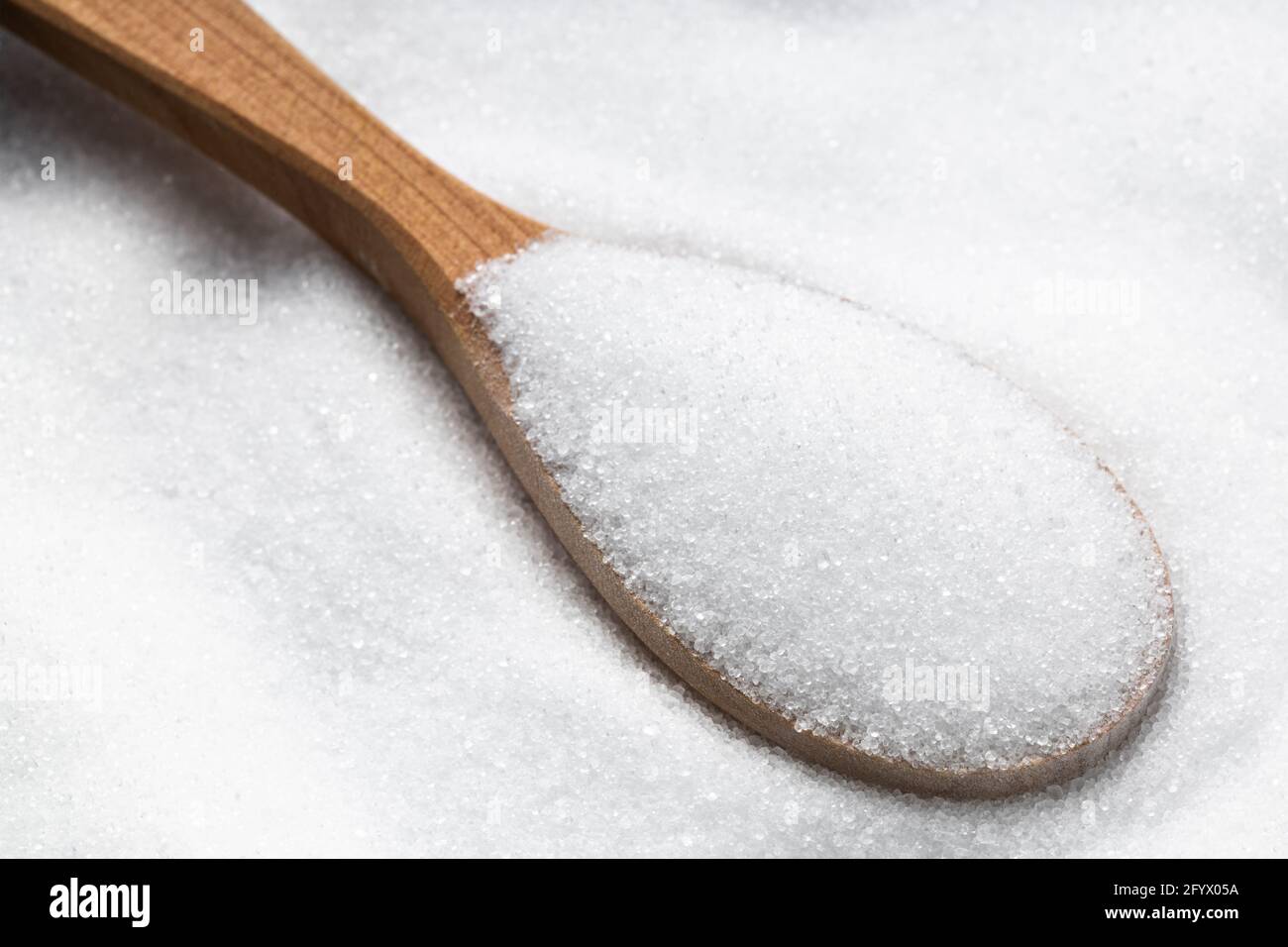 cucchiaio di legno con sostituto zucchero - estratto cristallino di stevia pianta primo piano su palo Foto Stock