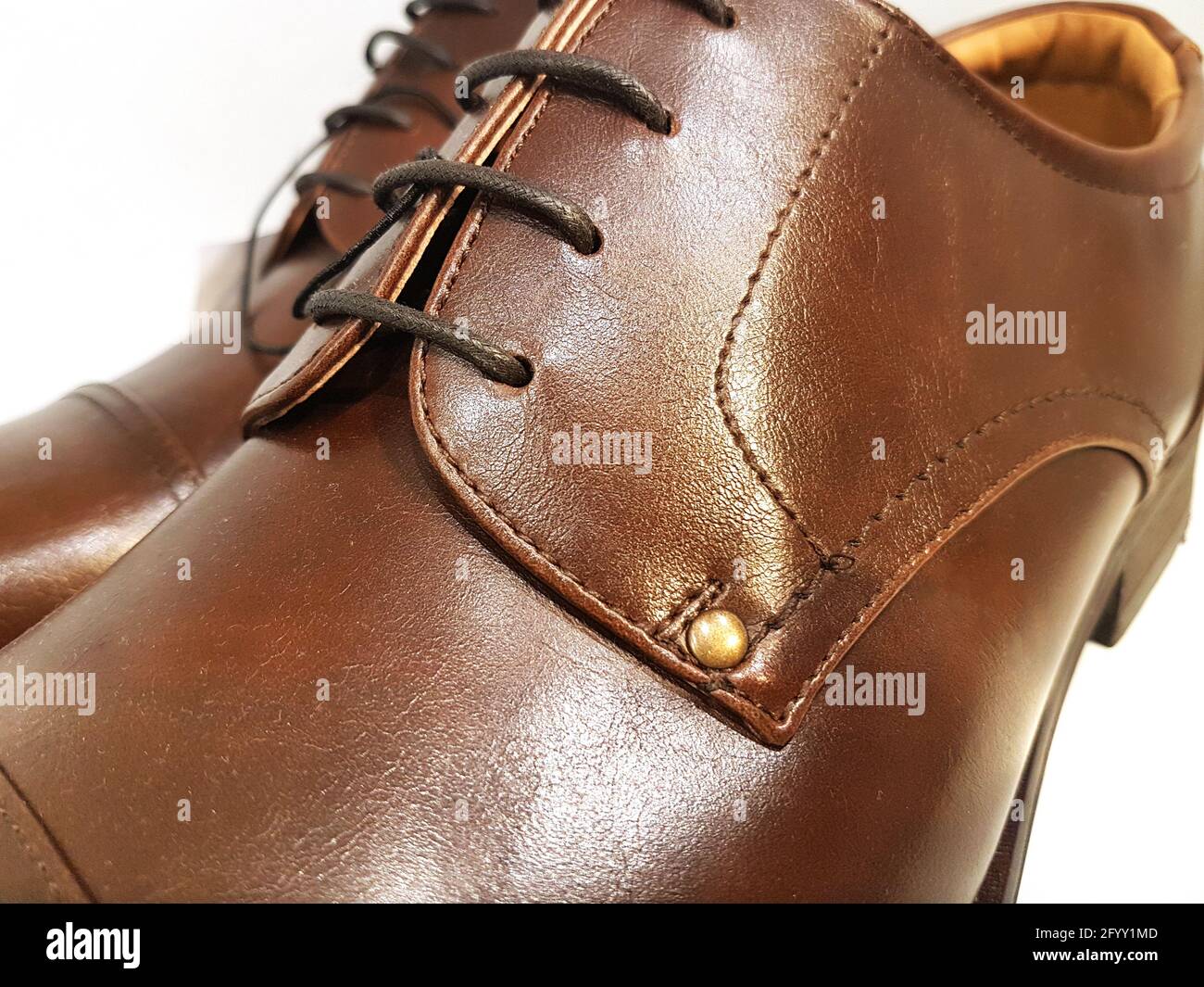 Scarpe classiche in pelle marrone maschile in primo piano su un bianco sfondo Foto Stock