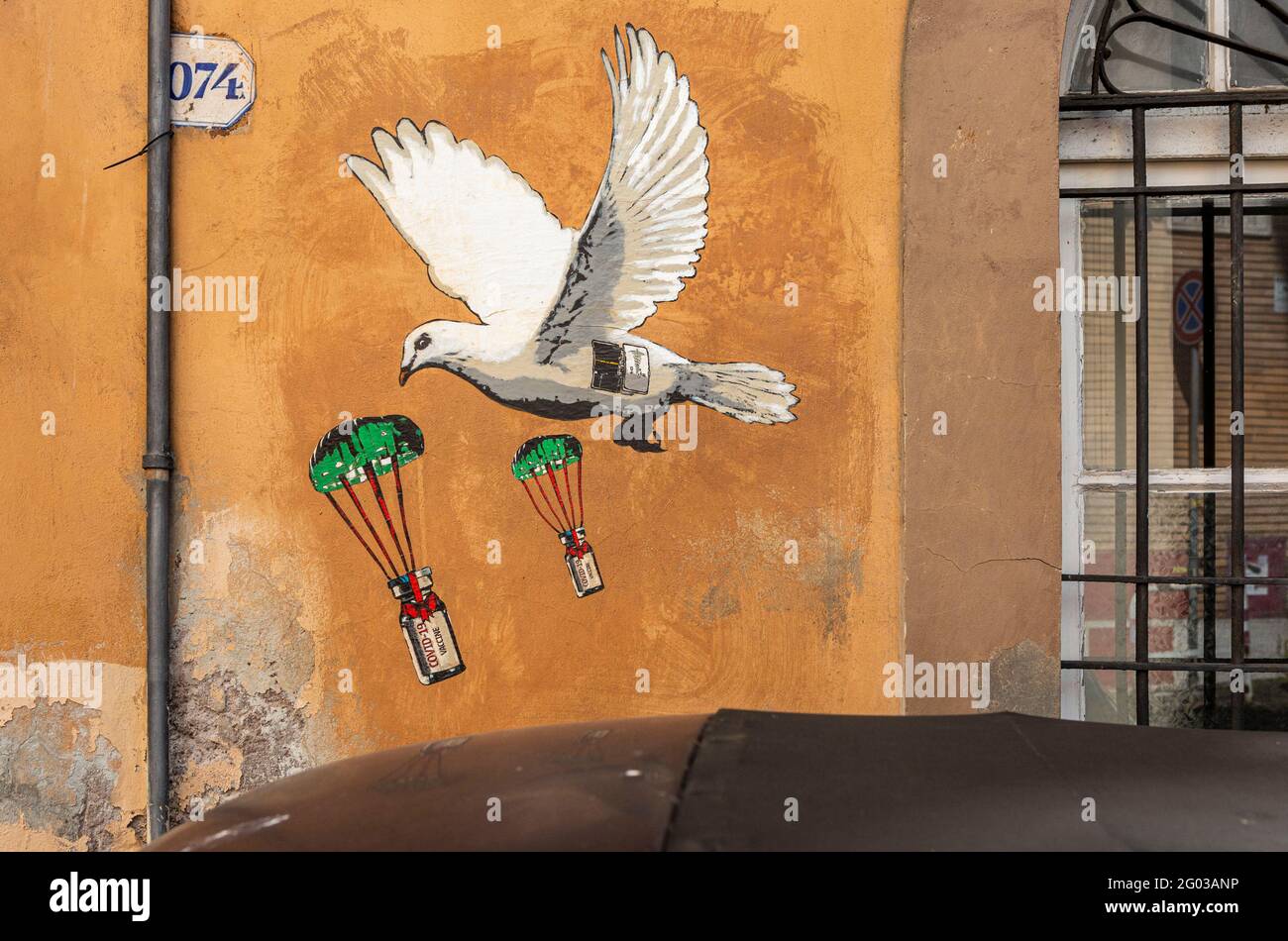 Arte di strada su muro di colomba contagiando i flaconcini di Covid Vaccino visto a Roma Foto Stock