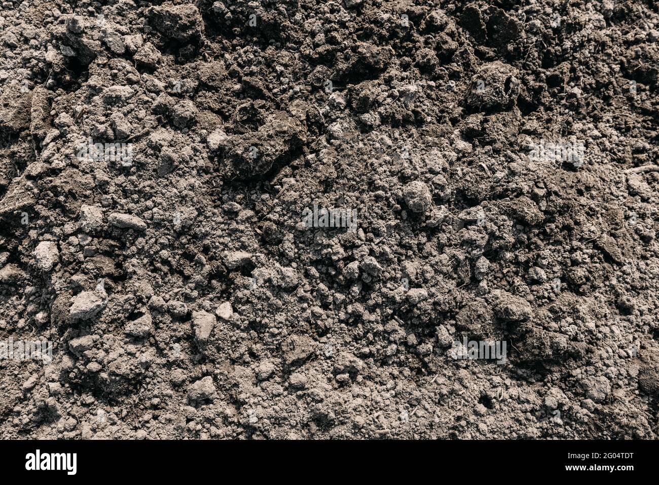 Nero terreno scuro sporco sfondo trama, modello naturale. Vista dall'alto. Zolle di terra Foto Stock
