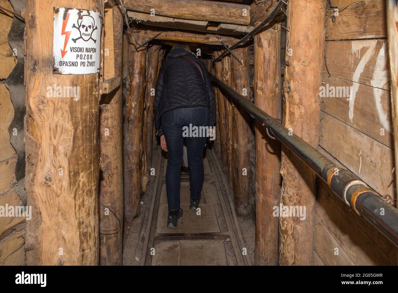 Per dare un'idea di altezza, visitatori accovacciati, Sarajevo Tunnel akaSvasa = Tunnel di salvataggio o Tunnel della speranza, Sarajevo, Bosnia e Herze Foto Stock