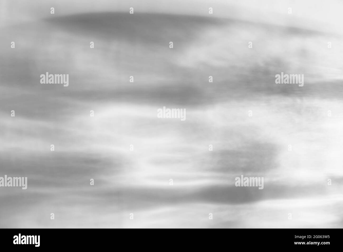 Il vetro lascia cadere l'ombra diagonale e l'effetto caustico leggero su una parete bianca. Caustiche formate dalla rifrazione del sole in una bottiglia su un tavolo luminoso. Raggi, Foto Stock