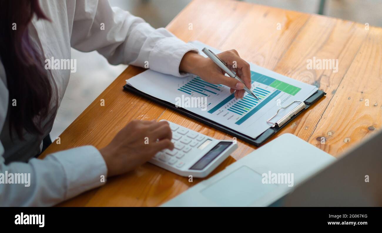 Financial Business Woman analizza il grafico delle prestazioni dell'azienda per creare profitti e crescita, report di ricerche di mercato e statistiche sul reddito Foto Stock