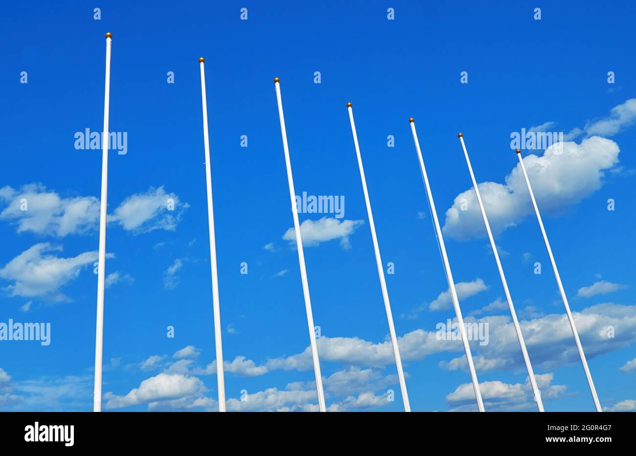 Flagpoli senza bandiere su uno sfondo di cielo blu Foto Stock