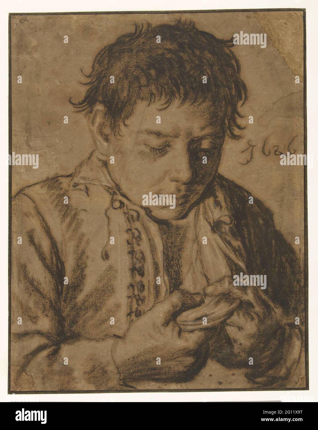 Ragazzo che raccoglie le pulci, a metà lunghezza. Foto Stock