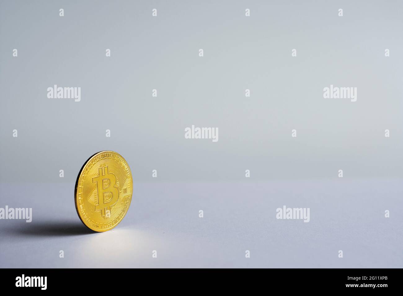 una moneta fisica davanti allo sfondo bianco. moneta a fuoco selettivo Foto Stock