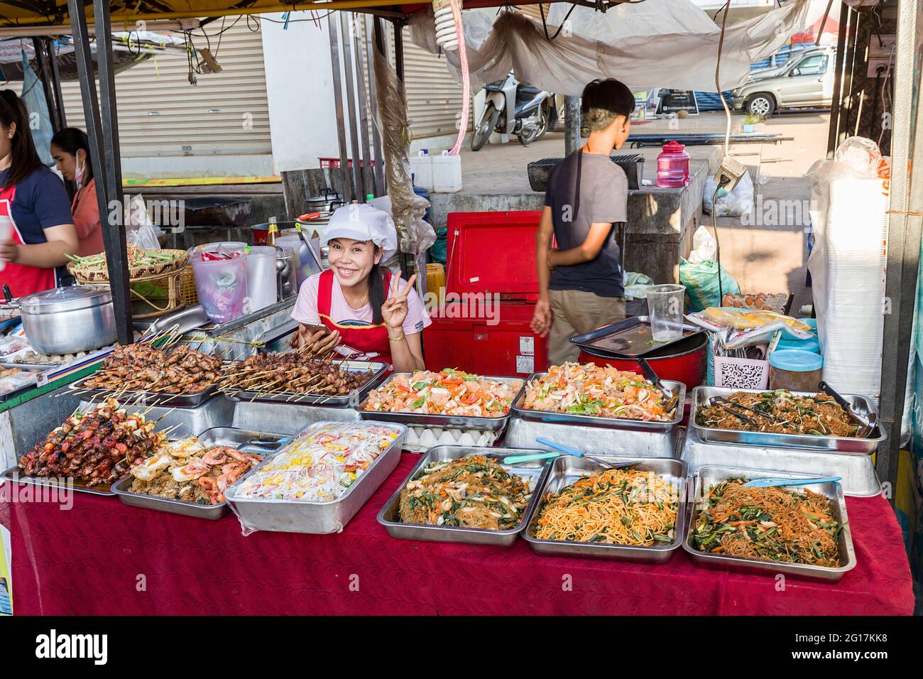 Cibo di strada caldo in vendita al chiosco con il venditore sorridente, Pakse, Laos Foto Stock