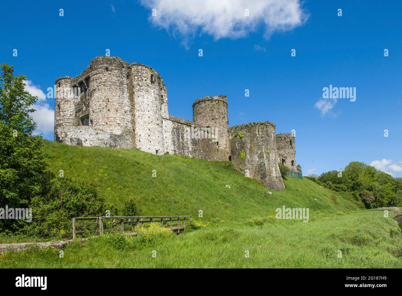Guardando verso il Castello di Cydweli da un sentiero pubblico che segue il fiume Gwendraeth nel villaggio di Kidwelly Foto Stock