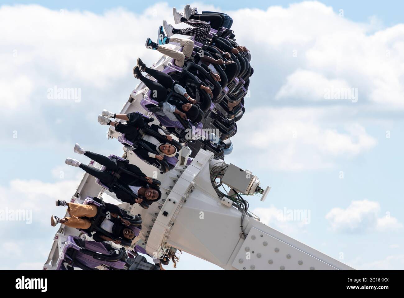 Le femmine etniche sull'asse cavalcano il brivido a Southend sul Mare, Essex, Regno Unito. Indossando sciarpe musulmane Hijab, godendosi il giro emozionante Foto Stock