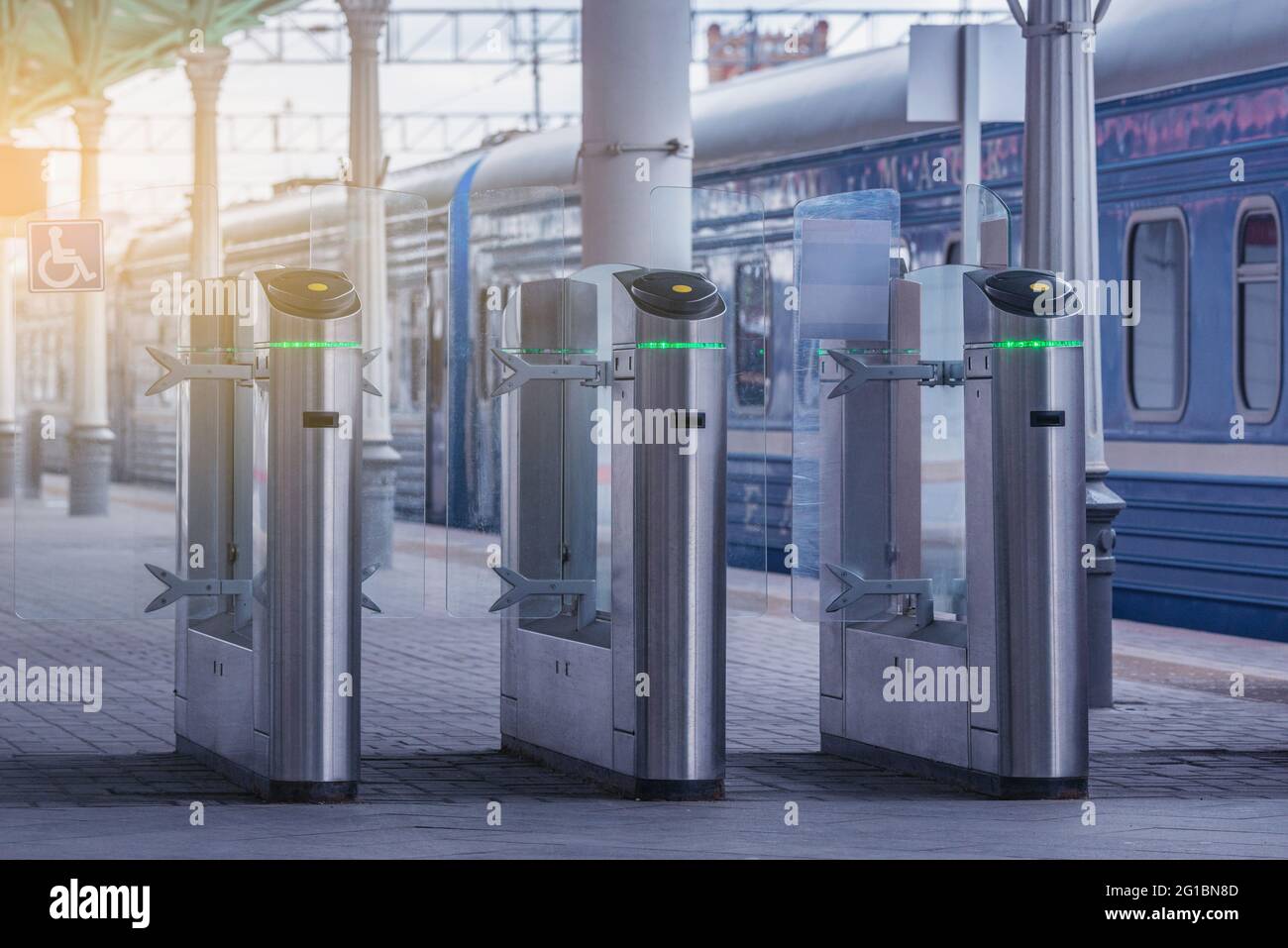 Tornelli con lettori di schede elettroniche sulla piattaforma della stazione. Foto Stock