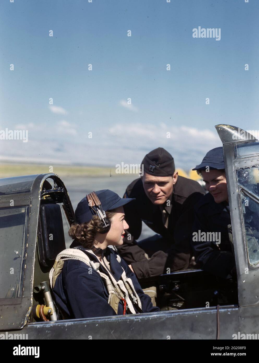 Non identificato Wasps e un istruttore maschile che parla prima di una delle donne piloti decollo per una missione di ferry, nessuna posizione, circa 1944. (Foto di US Army Air Force/RBM Vintage Images) Foto Stock