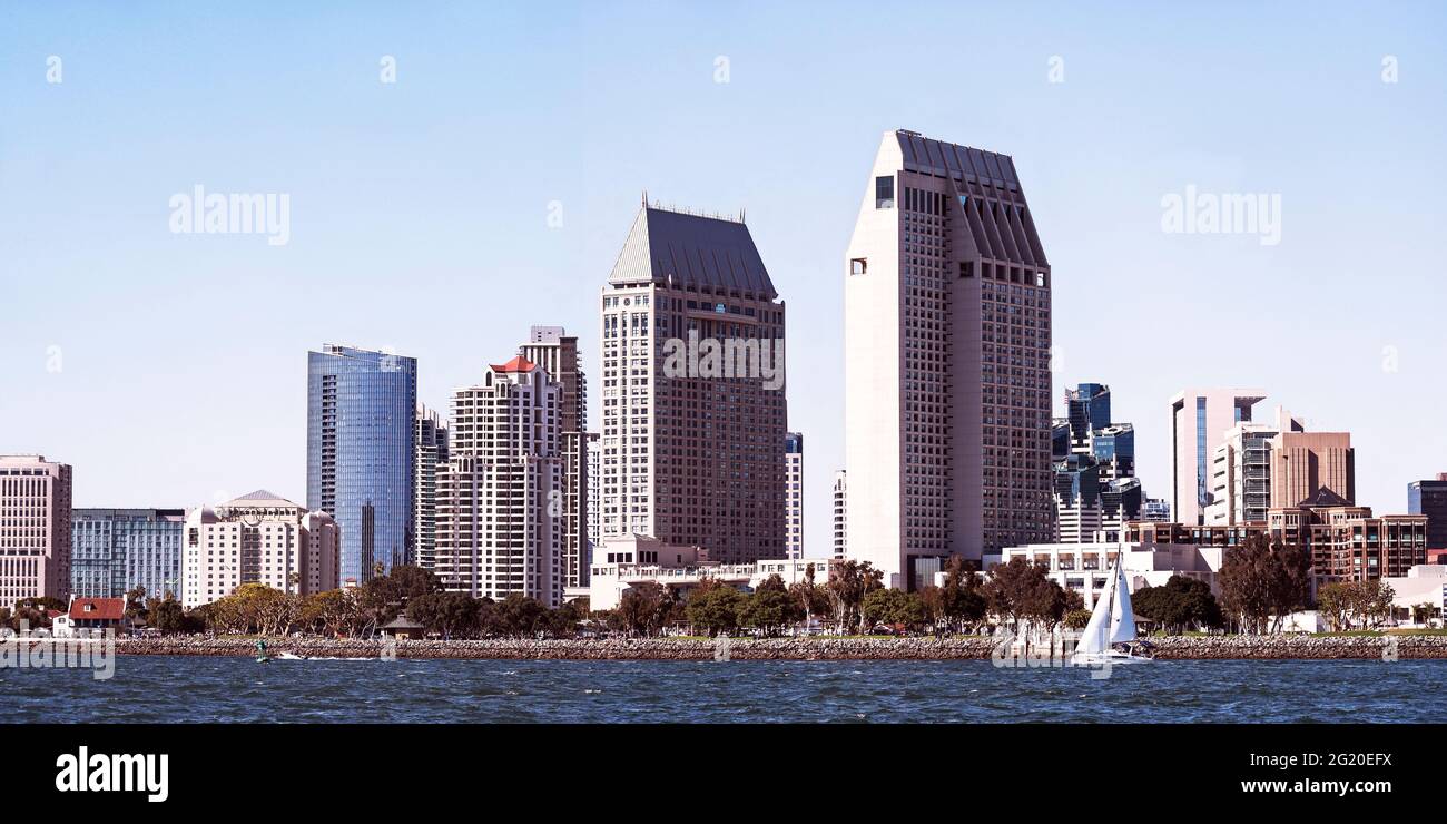 Lo skyline del centro di San Diego in California mostra i grattacieli, gli hotel e l'Embarcadero Marina Park con la Baia di San Diego e una singola barca a vela nel Foto Stock