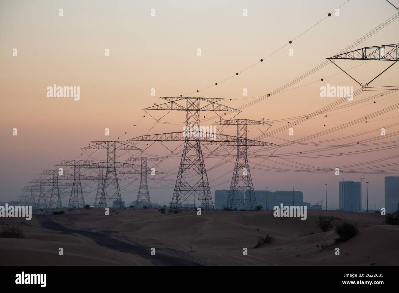 Torri di trasmissione nel deserto di Dubai al tramonto. Foto Stock