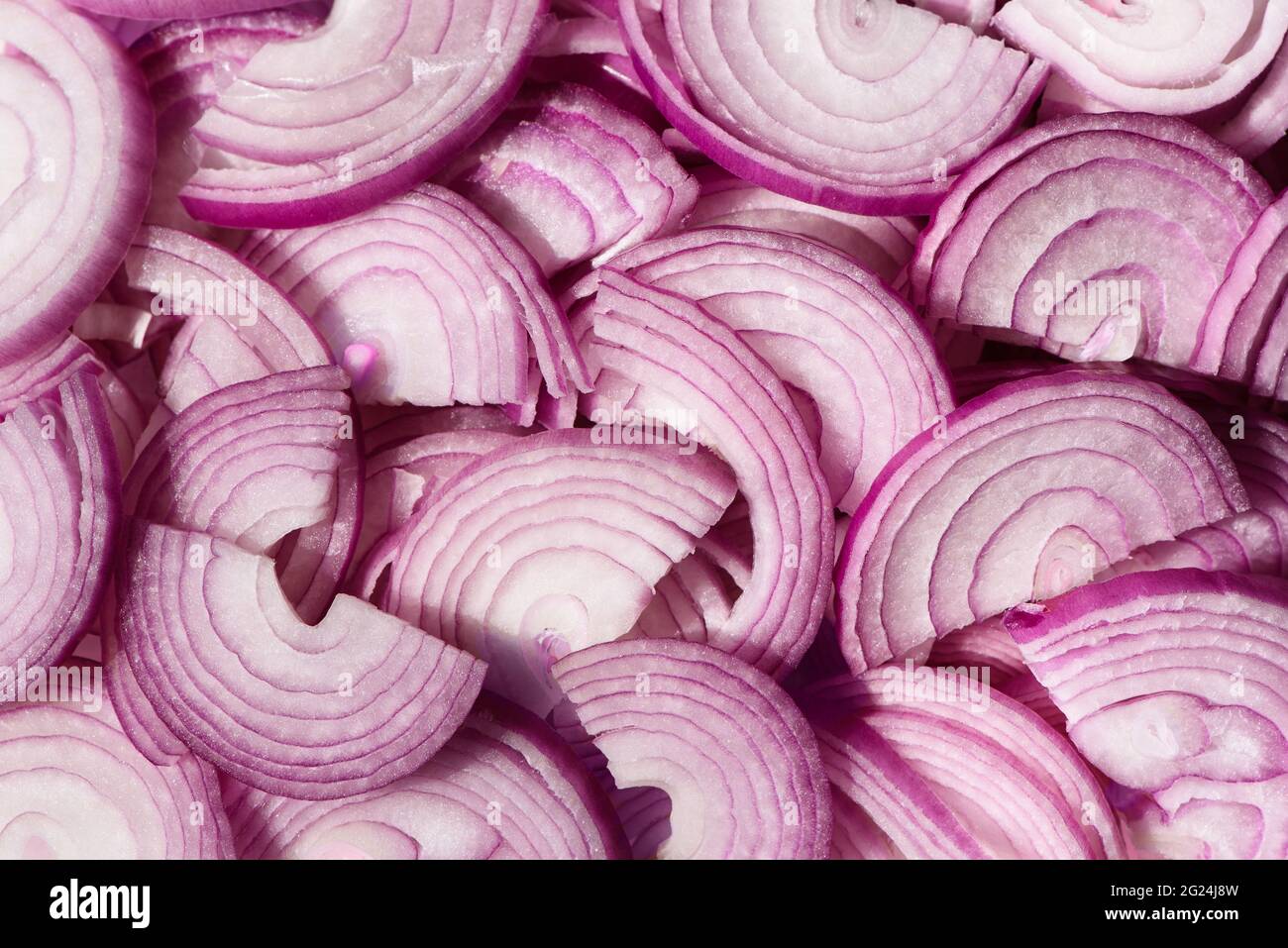 Cipolle viola a fette. Fette di cipolla rossa spagnola. Taglio orizzontale. Sfondo Foto Stock