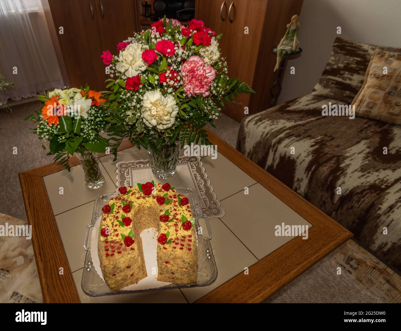 Grande gateau di colore dolce con fiori freschi di colore all'interno nel giorno di compleanno Foto Stock