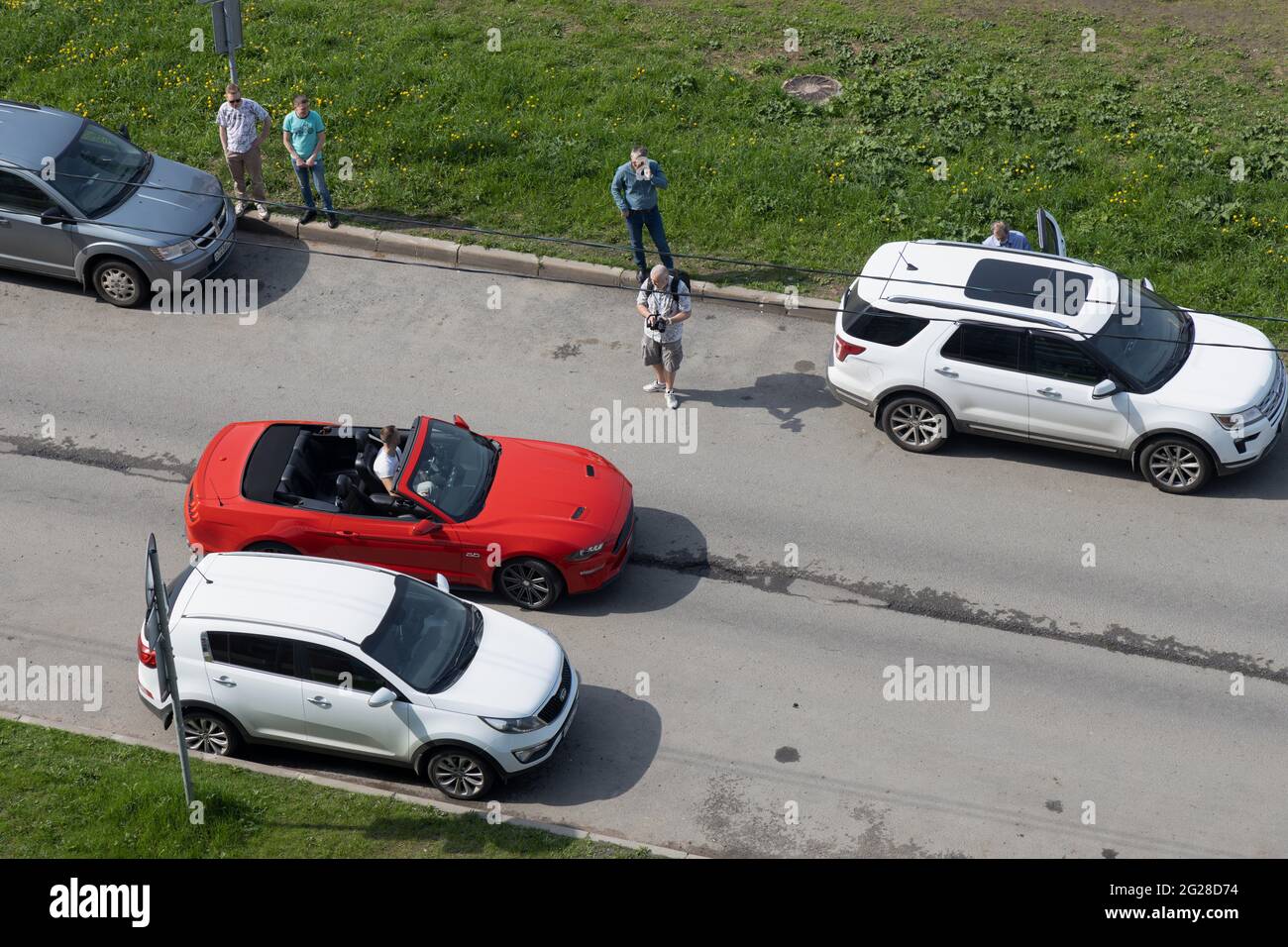 San Pietroburgo, Russia - 18 maggio 2021: Il videografo ha una vista laterale del driver nella vettura rossa ' Ford Mustang' vista dall'alto Foto Stock