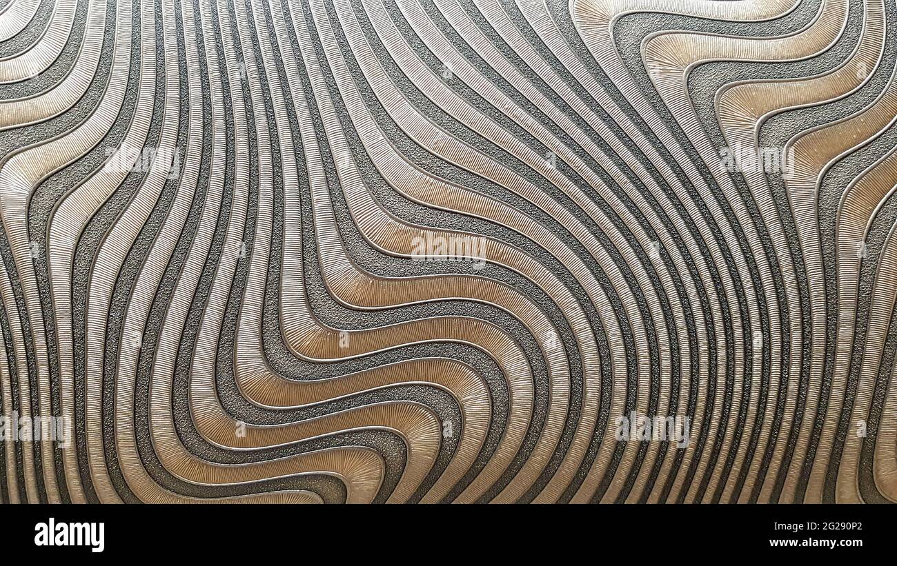Onda astratta foto texture parete sfondo grigio e colore oro. Texture senza cuciture. Sfondo ondulato. Decorazioni per pareti interne di interni moderni. Foto Stock