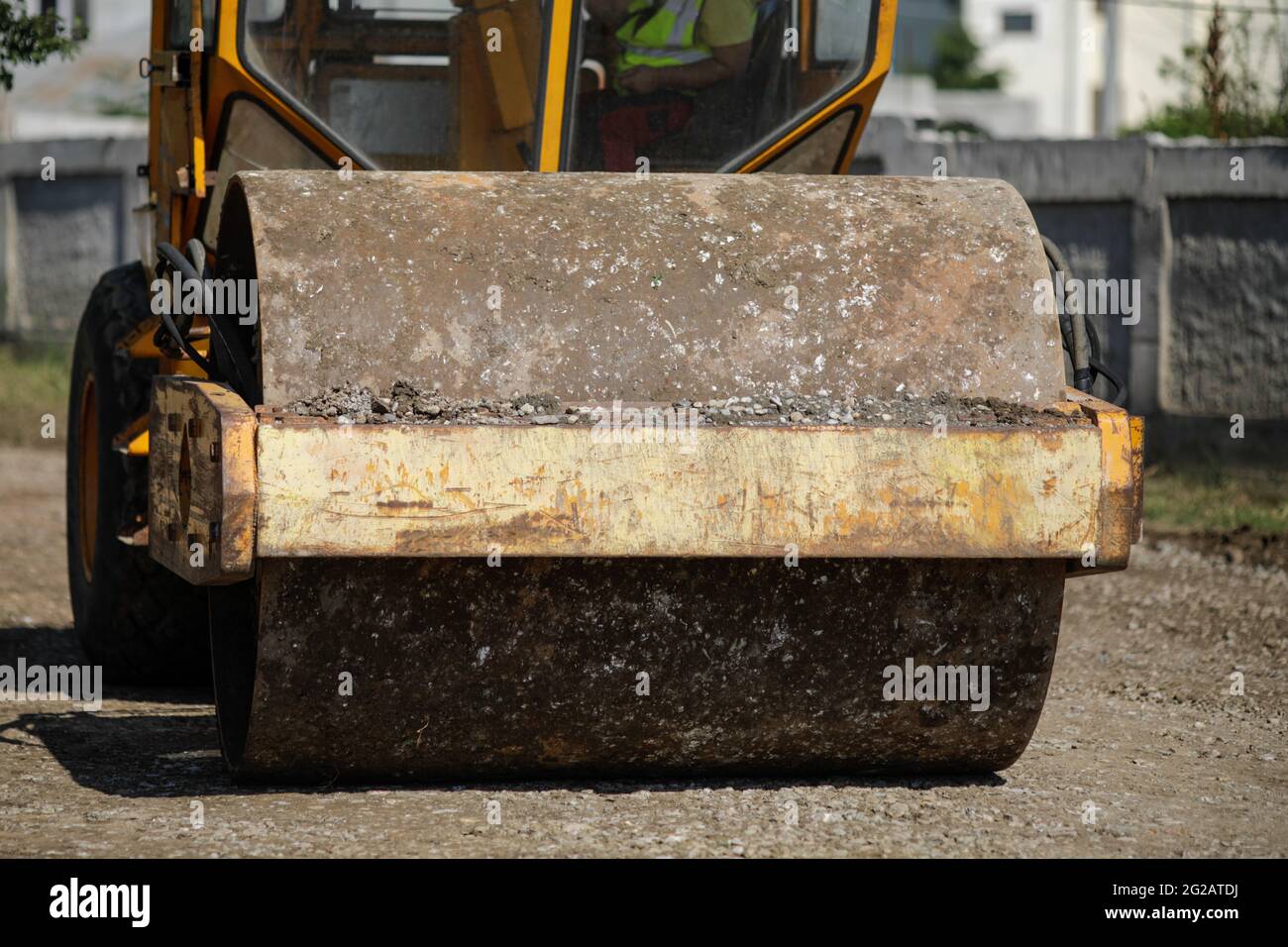 Dettagli della profondità di campo poco profonda (fuoco selettivo) con un rullo vibrante pesante (compattatore vibrante, rullo di compattazione) sul sito di costruzione di un r Foto Stock