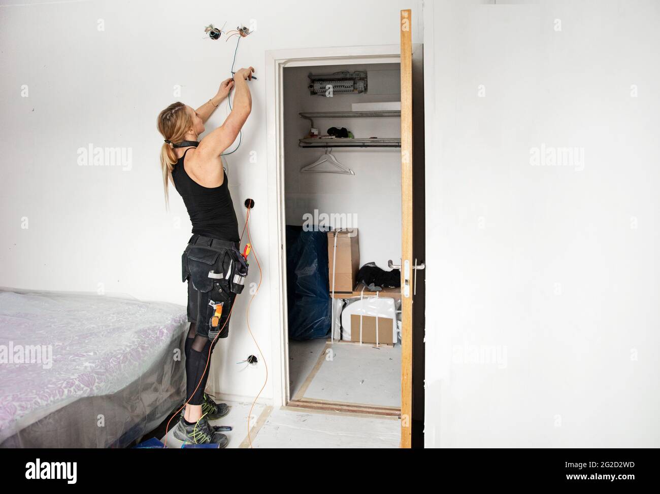 Elettricista femmina sul lavoro Foto Stock