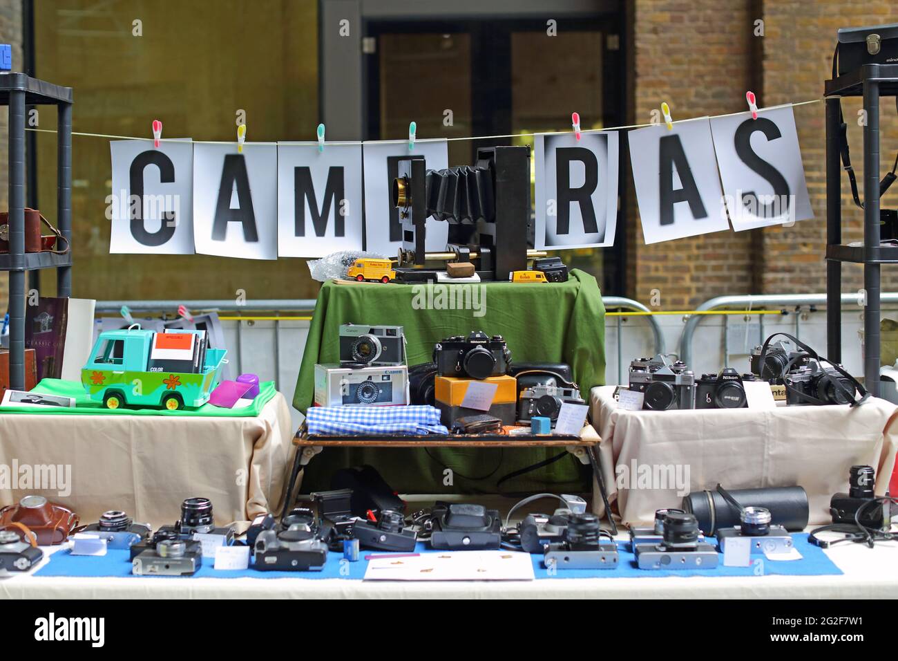 Vecchie fotocamere e obiettivi vintage in vendita in uno stand al Classic Car Boot sale a Granary Square a King's Cross London. Foto Stock