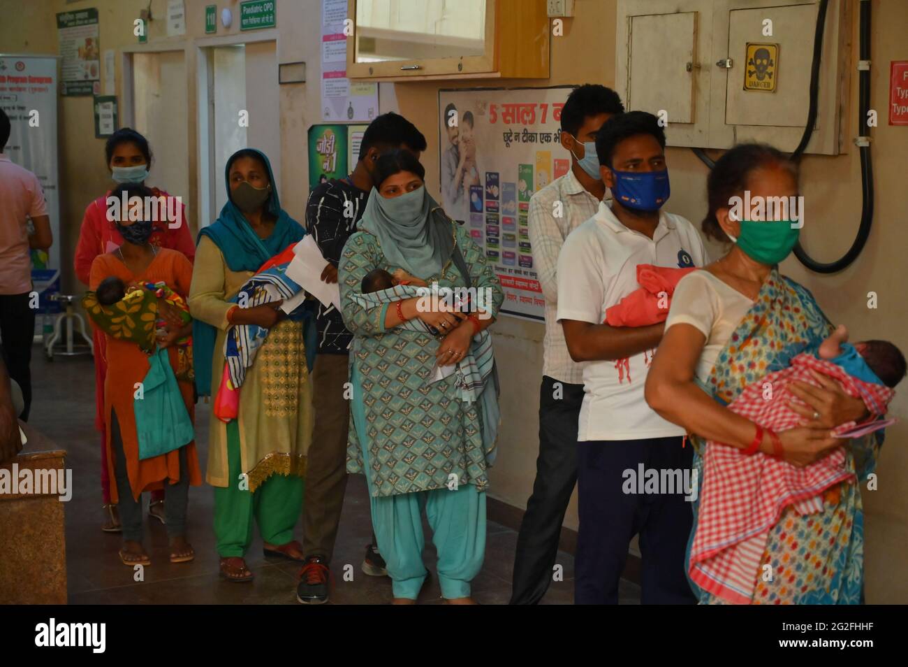 Neonato con i genitori in coda per la vaccinazione senza maschera presso il Sector-10 Government Hospital, gurgaon, haryana, india. 11 giugno 2021. Foto Stock