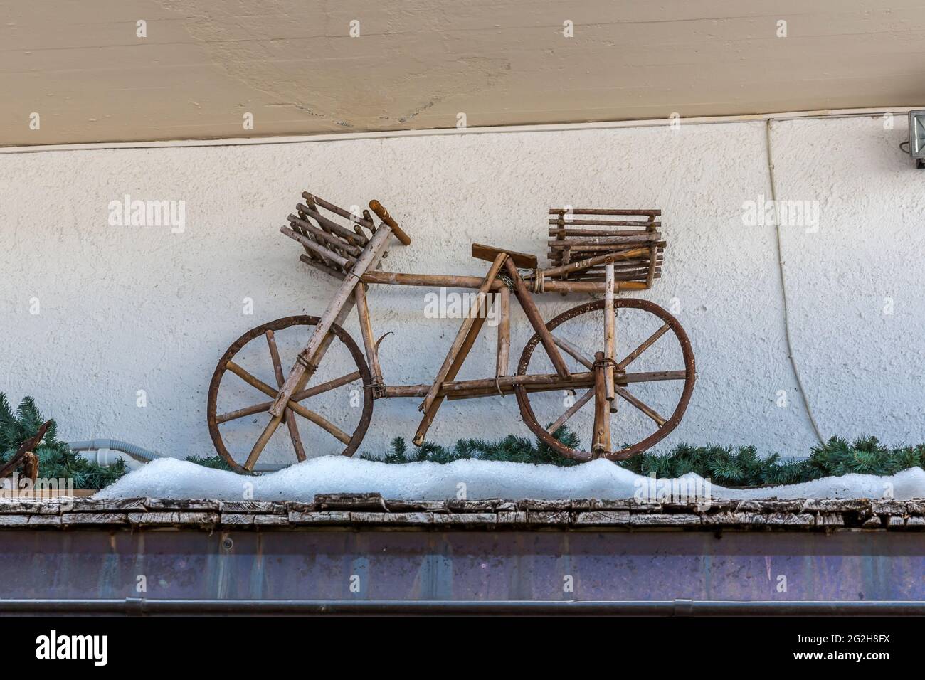 Bicicletta in legno sulla facciata di una casa, comprensorio sciistico Colfosco, Val Gardena, Passo Gardena, Sellaronda, Alto Adige, Alto Adige, Dolomiti, Italia, Europa Foto Stock
