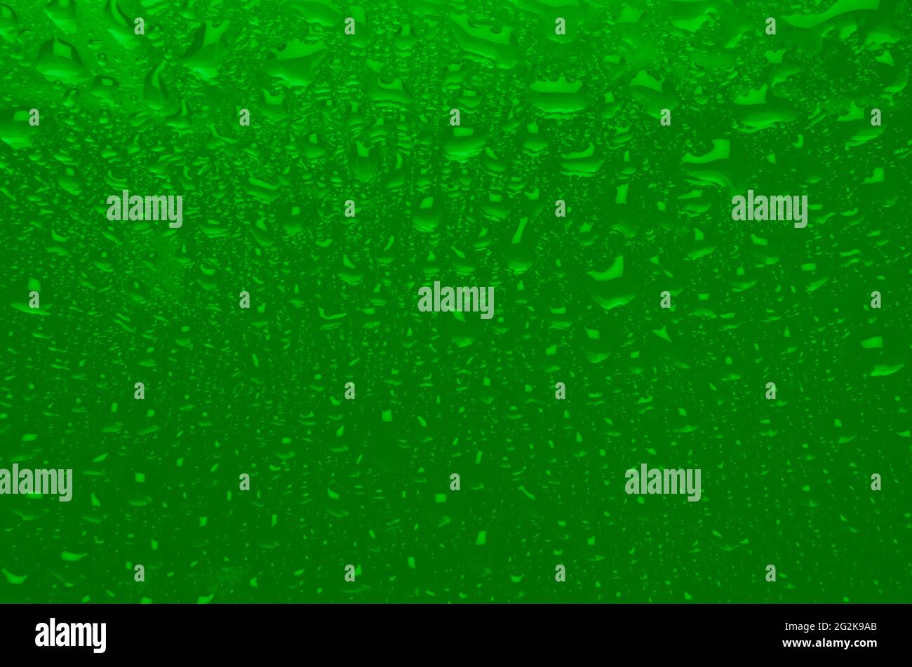 Tessuto bagnato verde saturo con gradiente e gocce. Sfondo di colore acido estivo o di scorie nucleari. Foto Stock