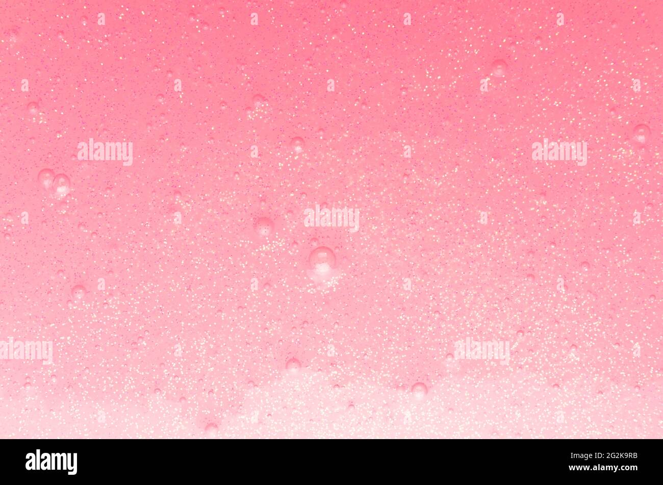 Tenue melma rosa chiaro con glitter oro e piccole bolle texture con gradiente, astratto sfondo girish. Foto Stock