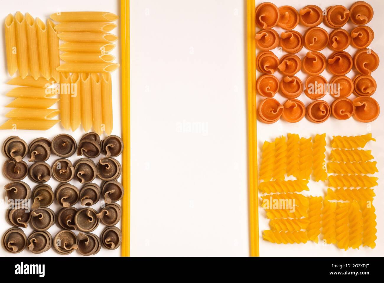 La pasta cruda di diversi tipi, forme e colori è divisa in quadrati dalla pasta cruda. Al centro c'è un posto per un'iscrizione Foto Stock