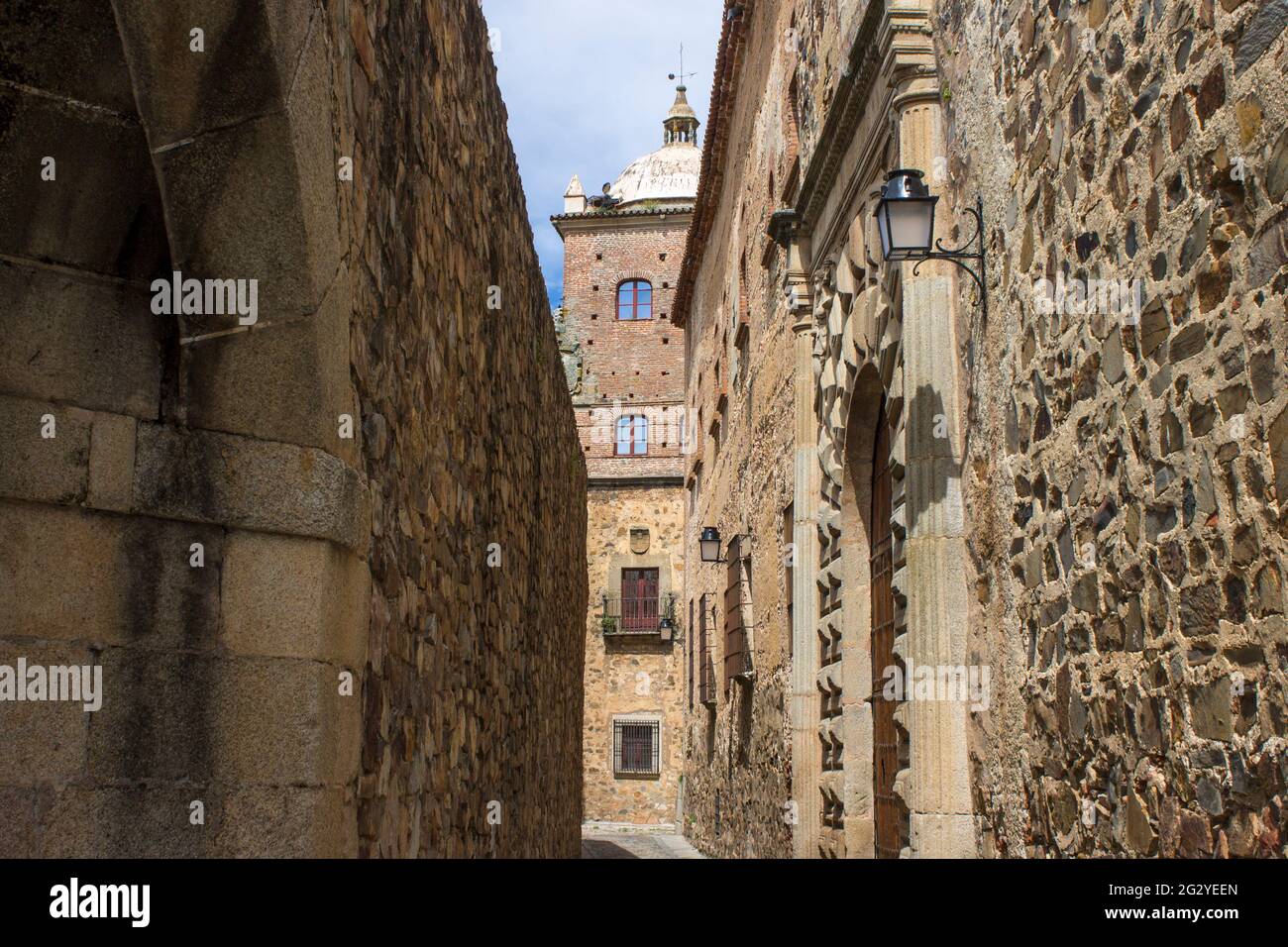 Caceres, Spagna. Uno degli adarves (bastioni) con il Palazzo di Toledo-Moctezuma nella Città Vecchia Monumentale, un sito Patrimonio dell'Umanità Foto Stock