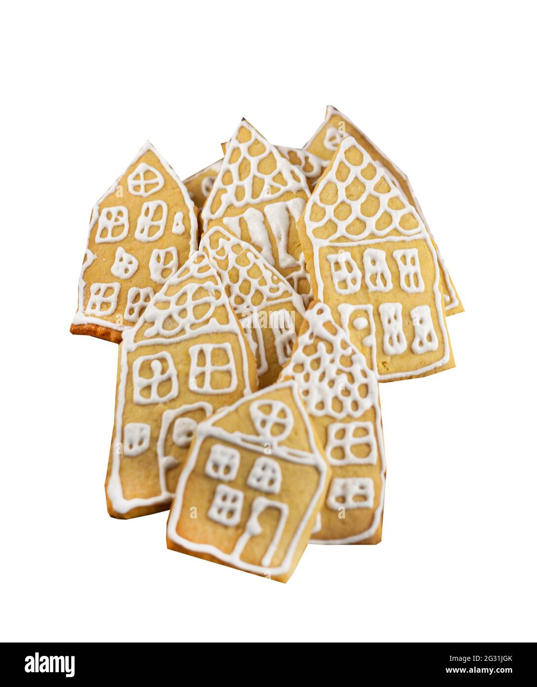 Biscotti di pan di zenzero isolati su uno sfondo bianco. Torte fatte in casa sotto forma di piccole case decorate con smalto bianco. Gruppo di pan di zenzero di Natale. Il cibo di Natale è un dolce, dessert. Foto Stock