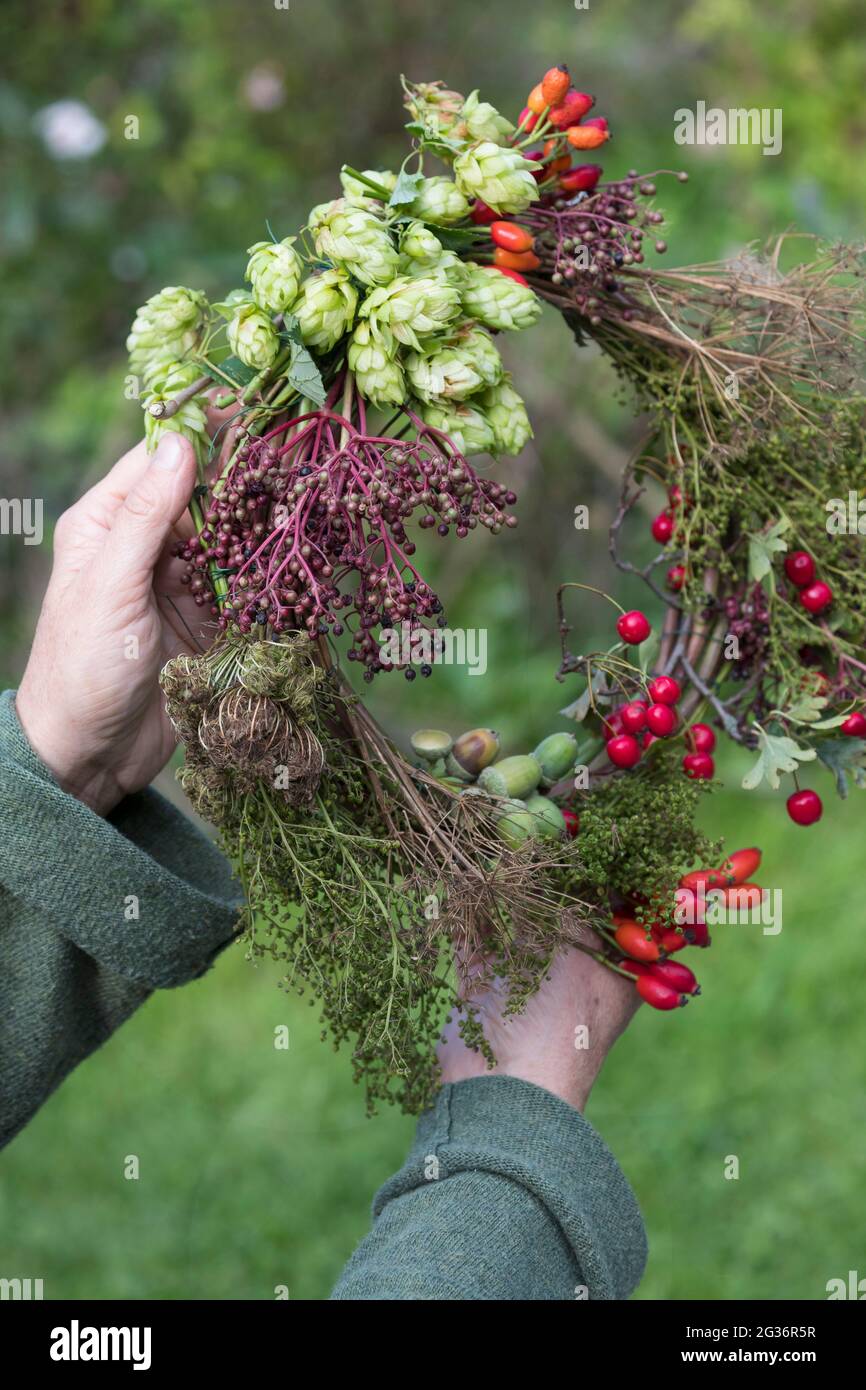 corona d'autunno realizzata con materiali naturali raccolti Foto Stock